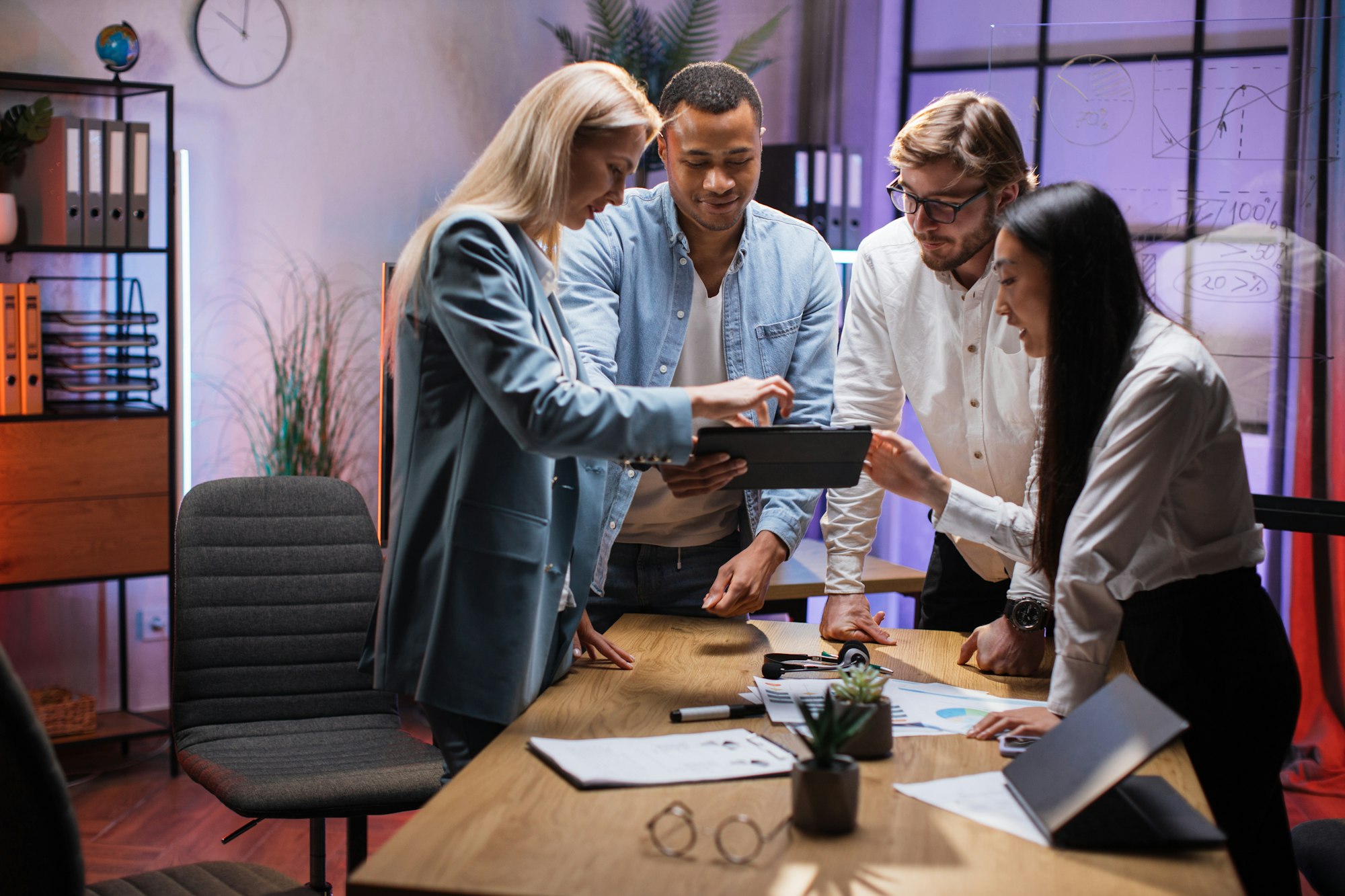 Team of financial experts using tablet during brainstorming